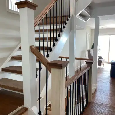 Staircase with dark wood handrail and hardwood flooring, Orlando FL