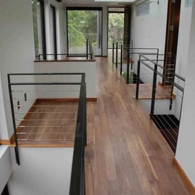 Hardwood flooring installation with glass panel stair railing in Orlando, FL home